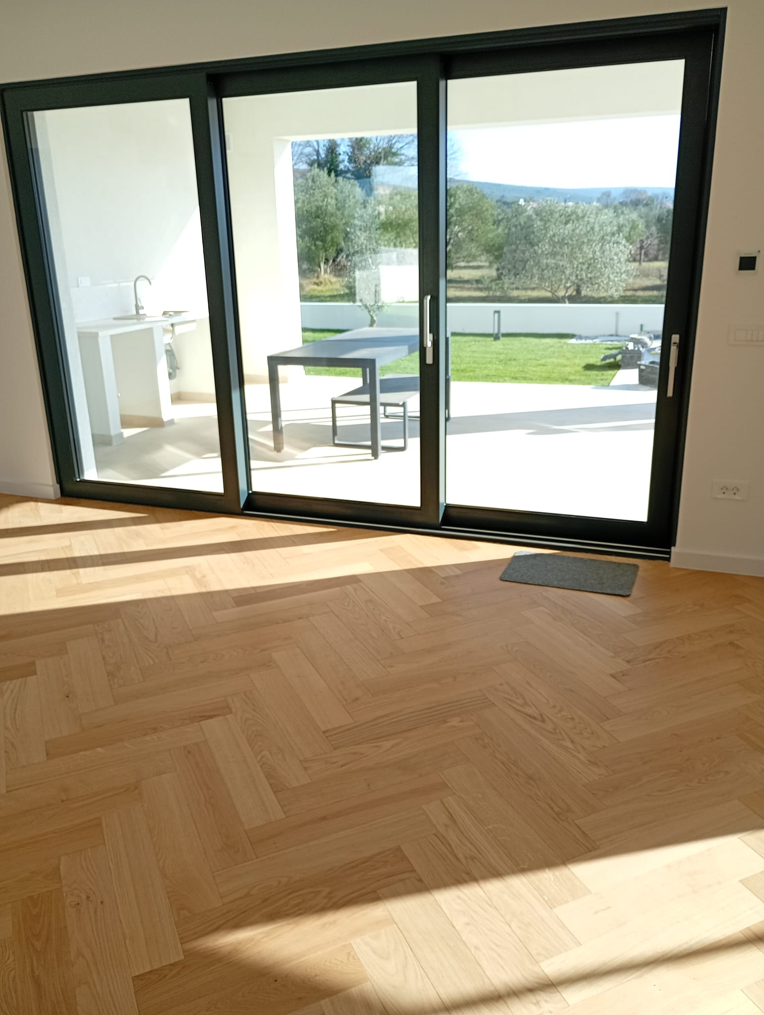 Spacious living room with herringbone wooden floor and ambient lighting in luxury villa Zadar Croatia